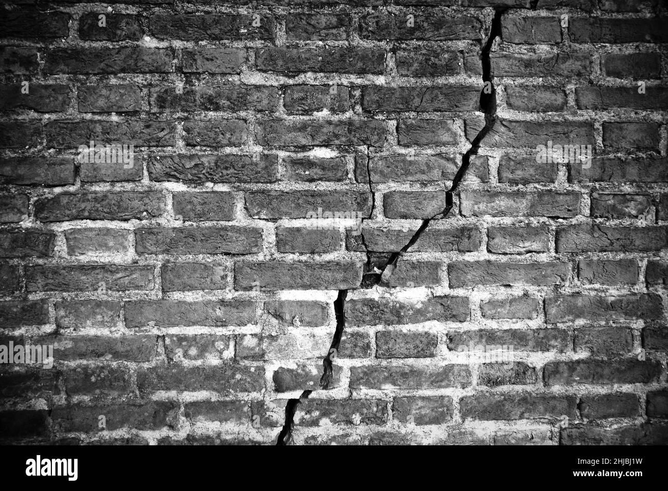 Old brick wall cracked and damaged - image with copy space Stock Photo