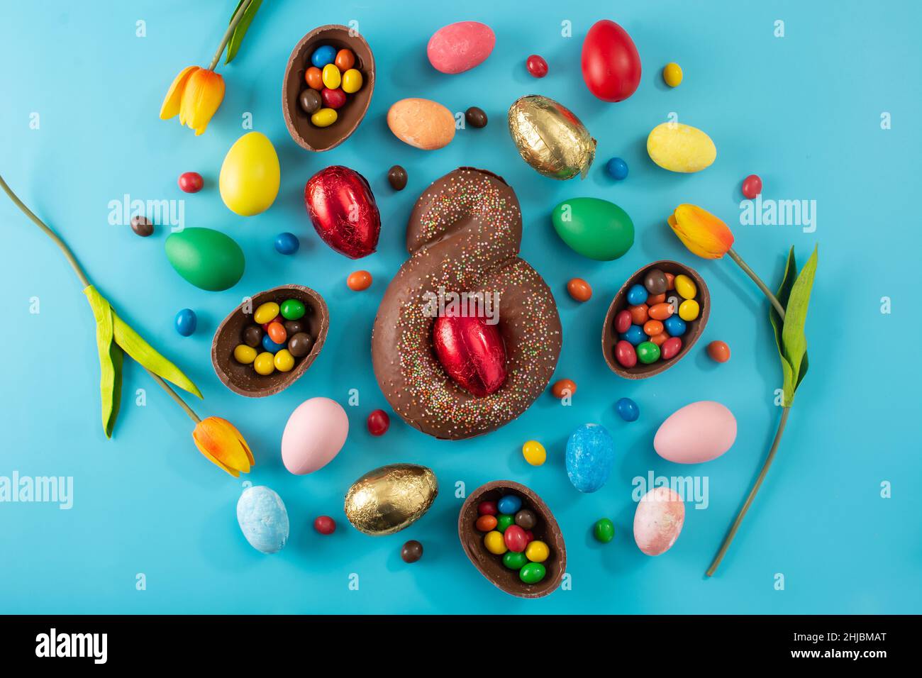 Mona de pascua cake and Easter eggs on blue background Stock Photo