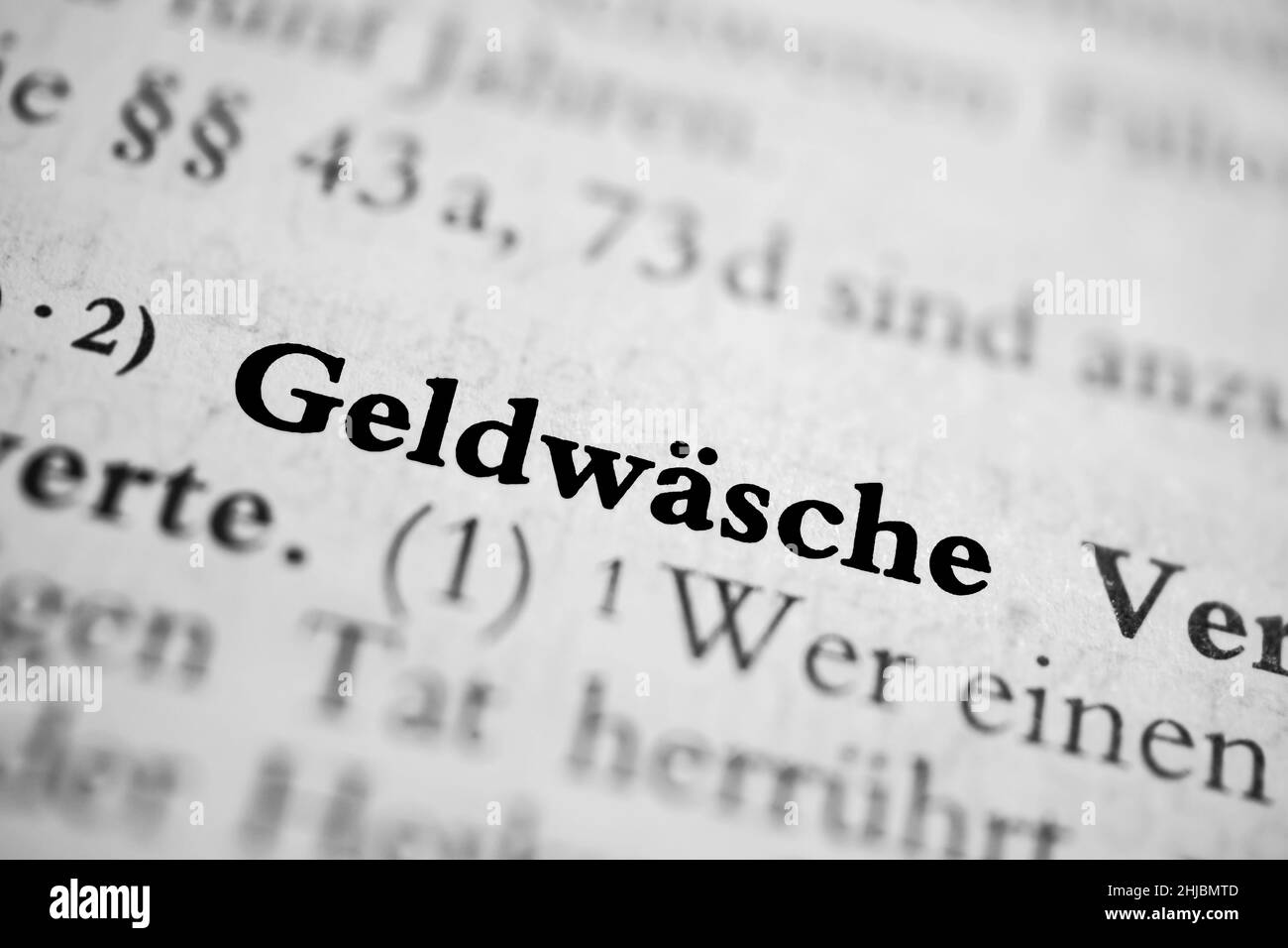 Closeup on the highlighted German word 'Geldwashce' in a newspaper. Translation: money laundering Stock Photo