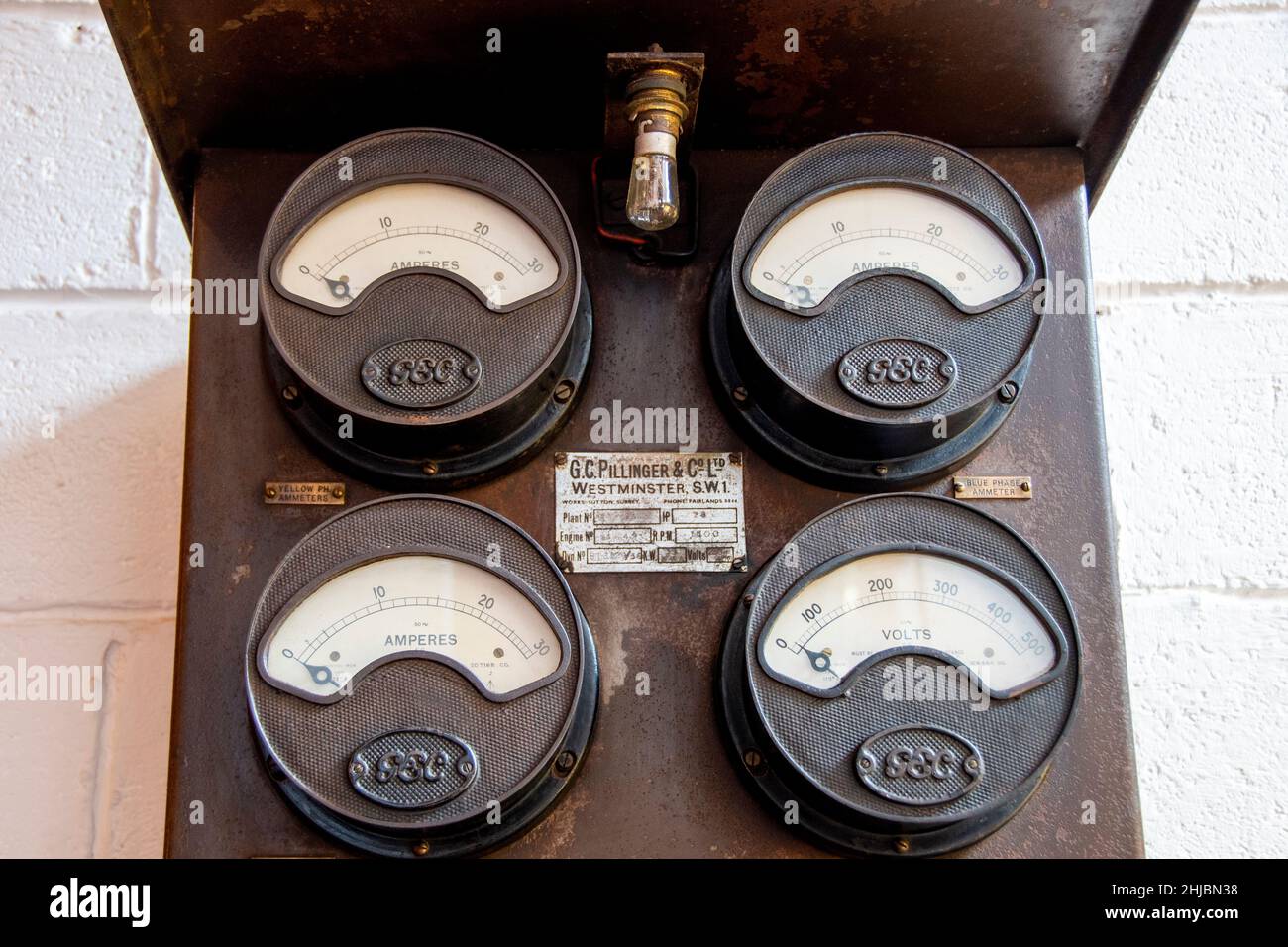 Sheffield,  UK - June 22: Antique electricity volt and amperes meter by G.C. Pillinger & Co in the hallway at Yellow Arch Studios, Kelham Island Stock Photo