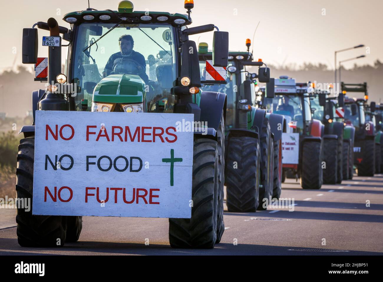 Schwerin, Germany. 28th Jan, 2022. A sign with the inscription 'No Farmers No Food No Future' hangs from a tractor during a column drive against the new fertilizer ordinance. With the action, the farmers wanted to demonstrate against the new draft of the state fertilizer ordinance and for effective protection of groundwater. They also criticize ever new bureaucratic regulations. Credit: Jens Büttner/dpa-Zentralbild/dpa/Alamy Live News Stock Photo