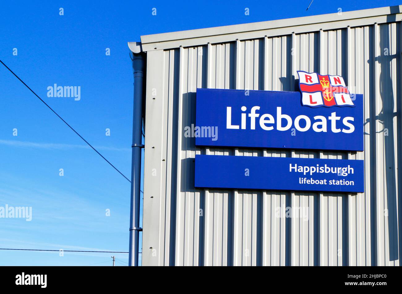 RNLI Lifeboats sign at the inshore Lifeboat Station on the North Norfolk coast at Cart Gap, Happisburgh, Norfolk, England, United Kingdom. Stock Photo