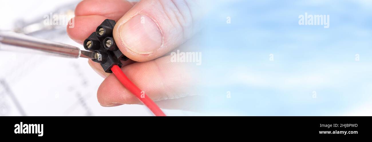 Clamping a wire in a connector, closeup Stock Photo