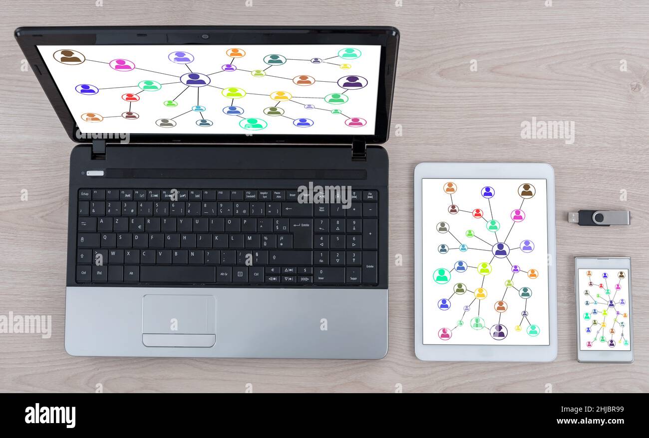 Social network concept shown on different information technology devices Stock Photo