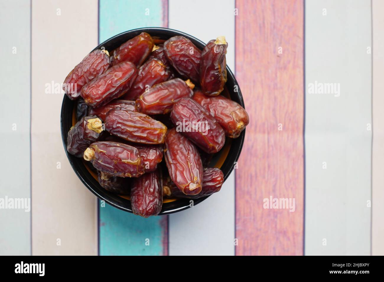 close up of fresh date fruit in a bowl on table  Stock Photo