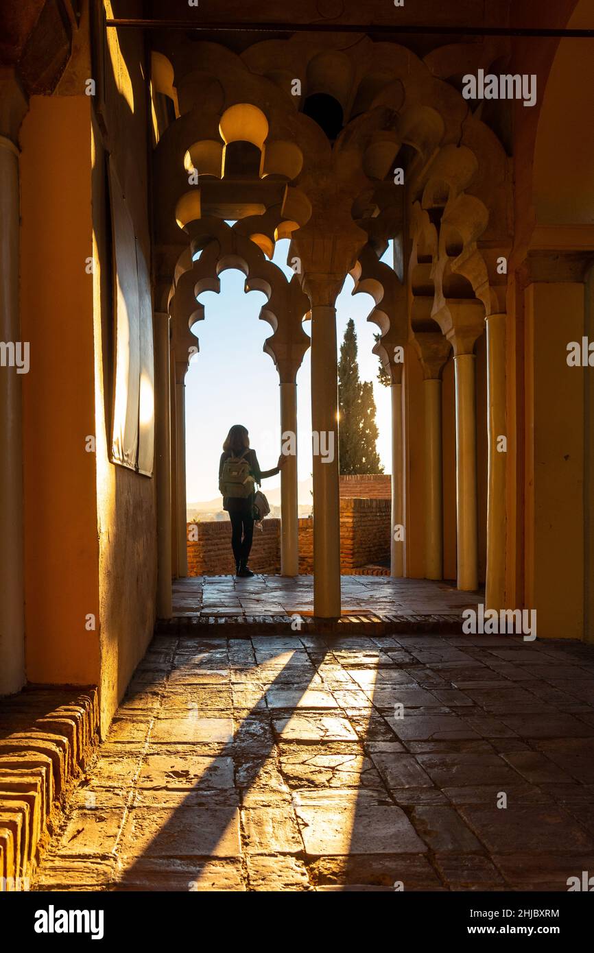 Tourist hunched over a column of the Arab doors of a courtyard of the ...