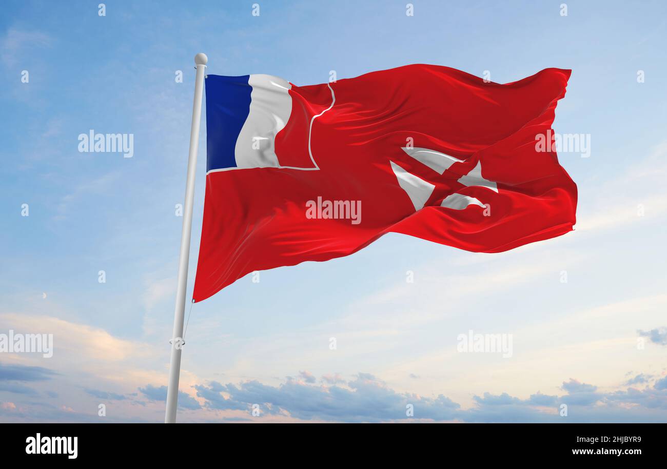 official flag of Wallis and Futuna at cloudy sky background on sunset ...