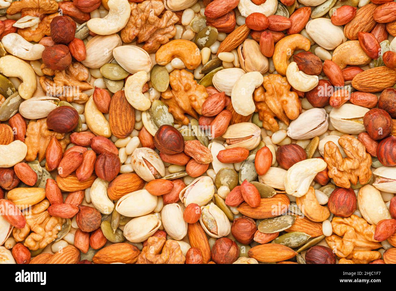 Background from different types of nuts and seeds peeled walnut