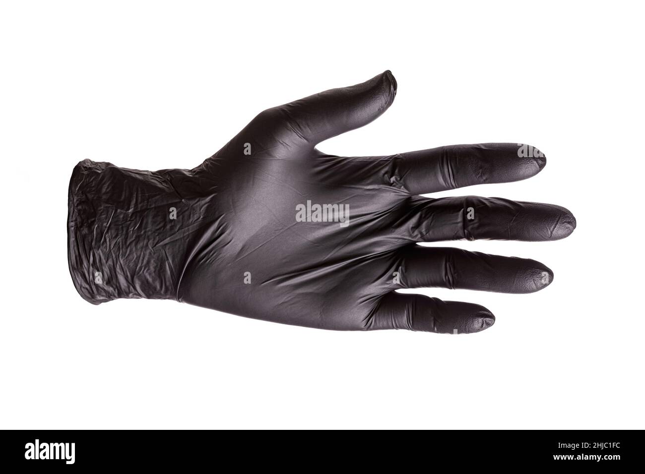 Black rubber glove worn on the hand, isolated on white background. Outstretched hand for handshake, closeup Stock Photo