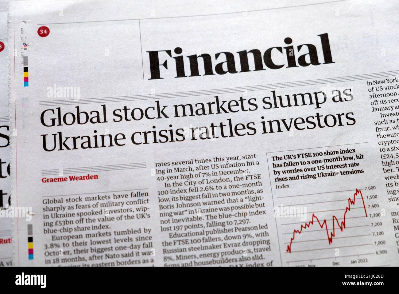 'Global stock markets slump as Ukraine crisis rattles investors'  Financial page of Guardian newspaper headline 24 January 2022 in London UK Stock Photo