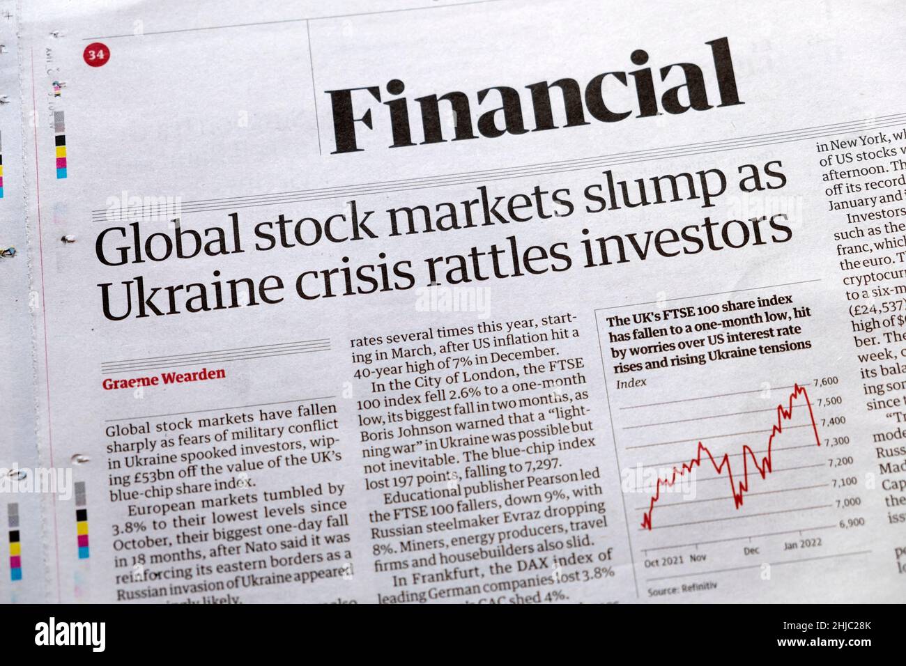 'Global stock markets slump as Ukraine crisis rattles investors'  Financial page of Guardian newspaper headline 24 January 2022 in London UK Stock Photo