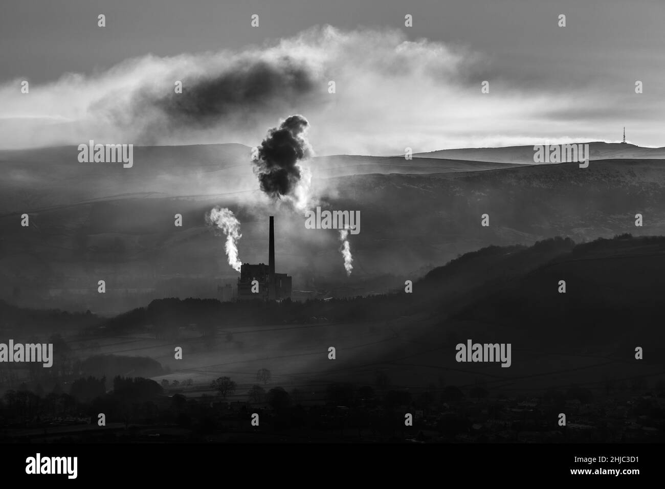 Dramatic grayscale shot of smoke coming out from a factory Stock Photo
