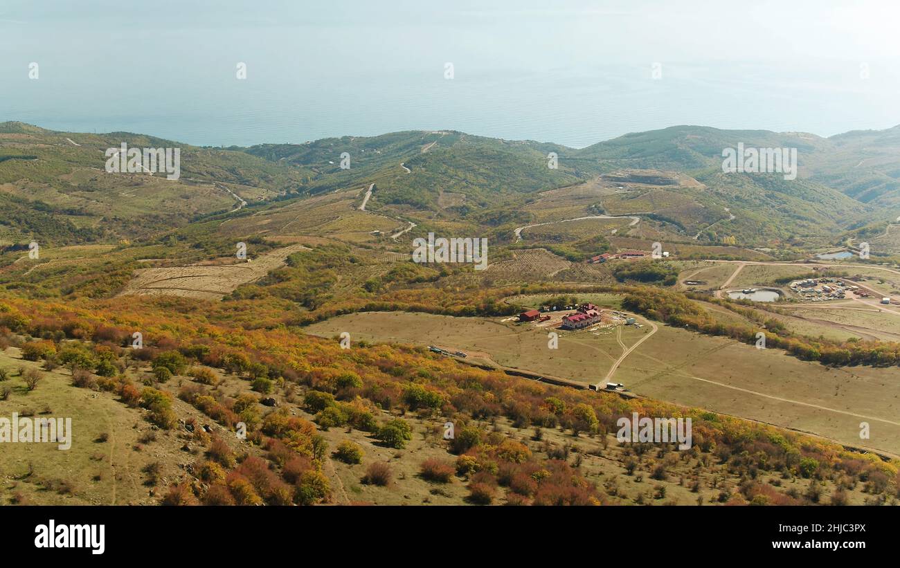 Aerial view of a green rural area under blue sky. Shot. Idyllic green ...