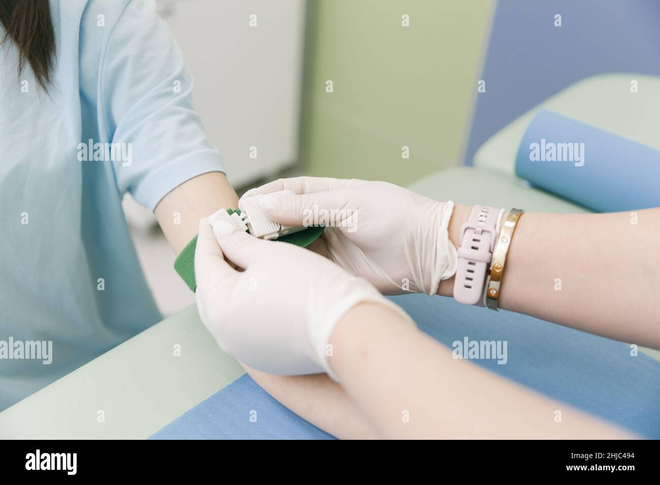 Taking A Blood Test From A Vein In The Treatment Room Nurse Pricking A taking-a-blood-test-from-a-vein-in-the-treatment-room-nurse-pricking-a