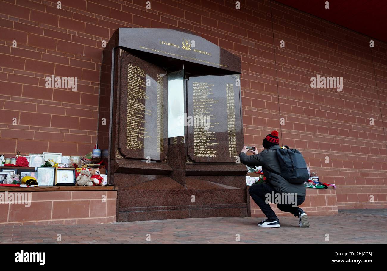 A passer-by takes a photograph of the updated monument after Andrew ...