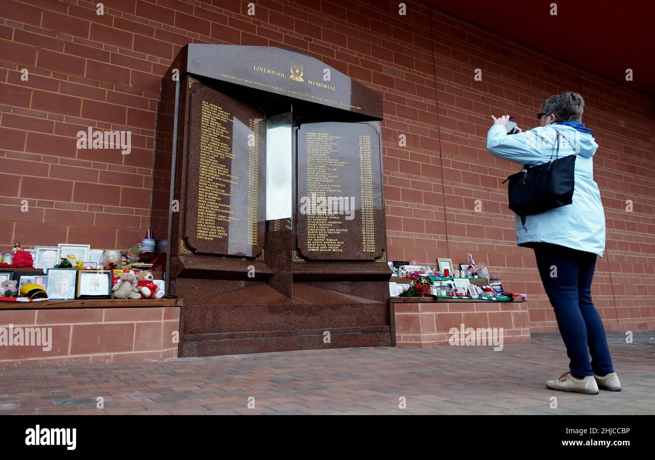 A passer-by takes a photograph of the updated monument after Andrew ...