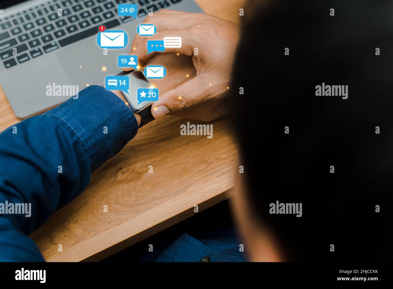 People using social media marketing ideas on smart watches. with notification icons like, messages, comments and stars Stock Photo