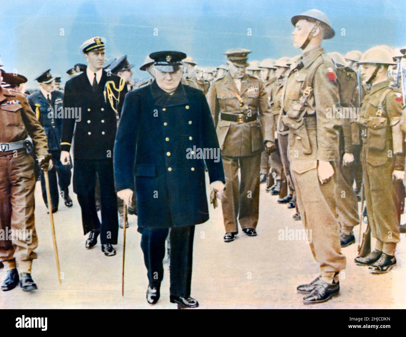 Winston Churchill. British statesman who served as Prime minister of the United Kingdom from 1940 to 1945 during the Second world war. Born on november 30 1874, dead january 24 1965. Pictured inspecting troubs walking along the men together with other officers. Stock Photo