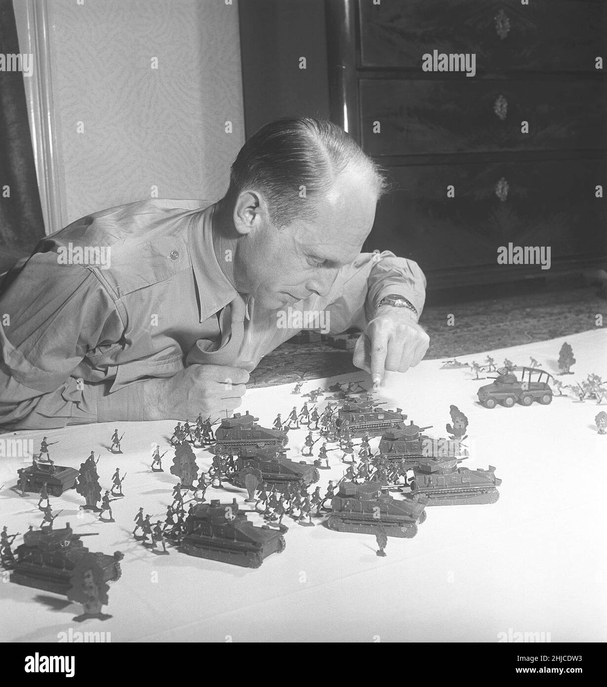 Tin soldiers in the 1950s. A member of the danish tin figure collectors with a his collection of tin soldiers and tin toys. Tin soldiers were a historic hobby often in themes. Tin was melted and poured into forms of the figures that when they had cooled off and taken out of the forms were painted carefully. 1952. Kristoffersson ref BE30-10 Stock Photo