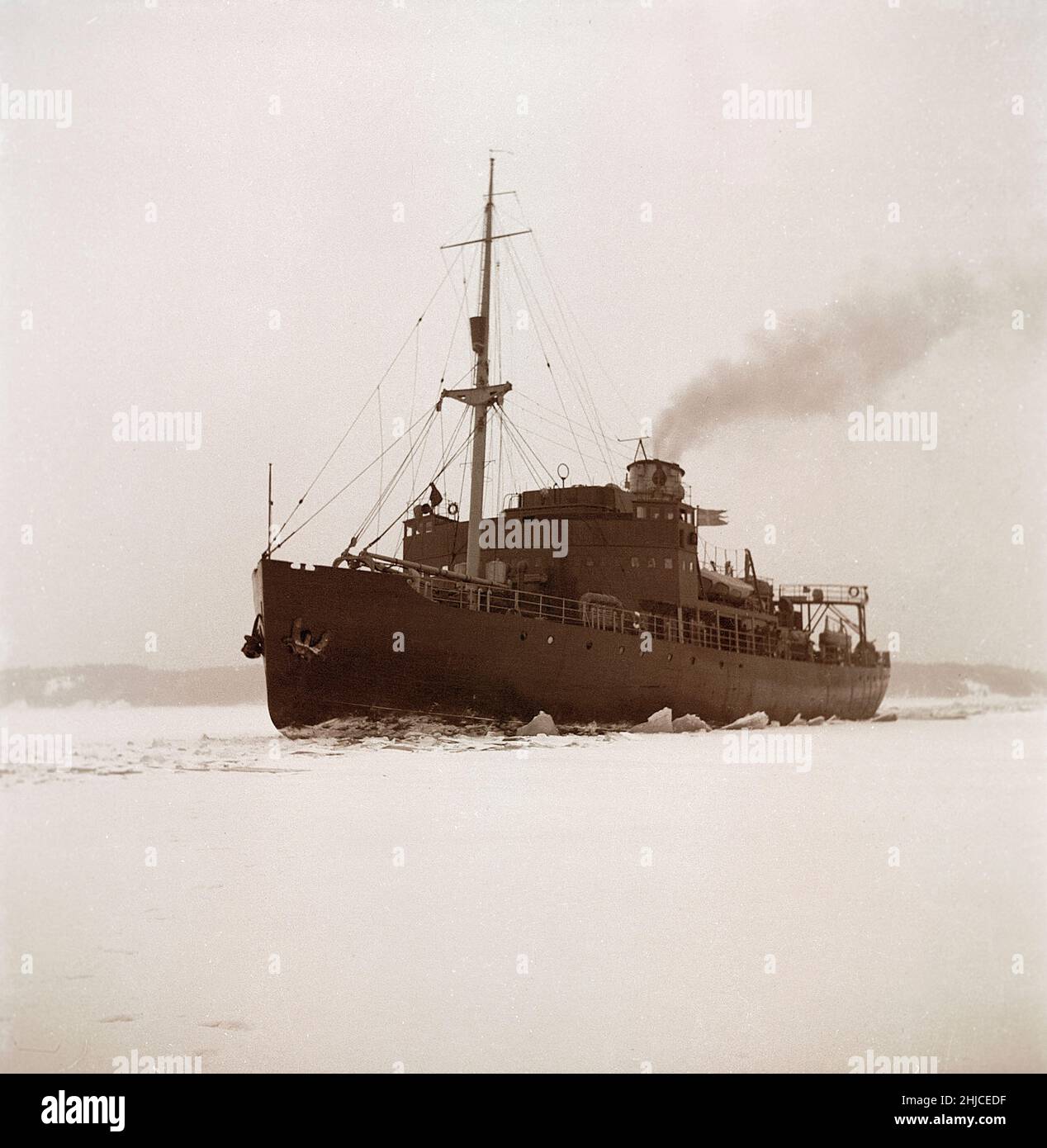 Winter at sea in the 1940s. Pictured the swedish icebreaker Ymer breaking the ice in the inner waters at the swedish coast in febrary 1941. The icebreaker Ymer was built in Malmö 1931-1933 and served as a state icebreaker for 44 years until she was sold and scrapped 1976. The winters during the World war II was often exceptionally cold and the ice became a big problem for the shipping industry and for the military.  Sweden 1942 Kristoffersson ref 172-5 Stock Photo