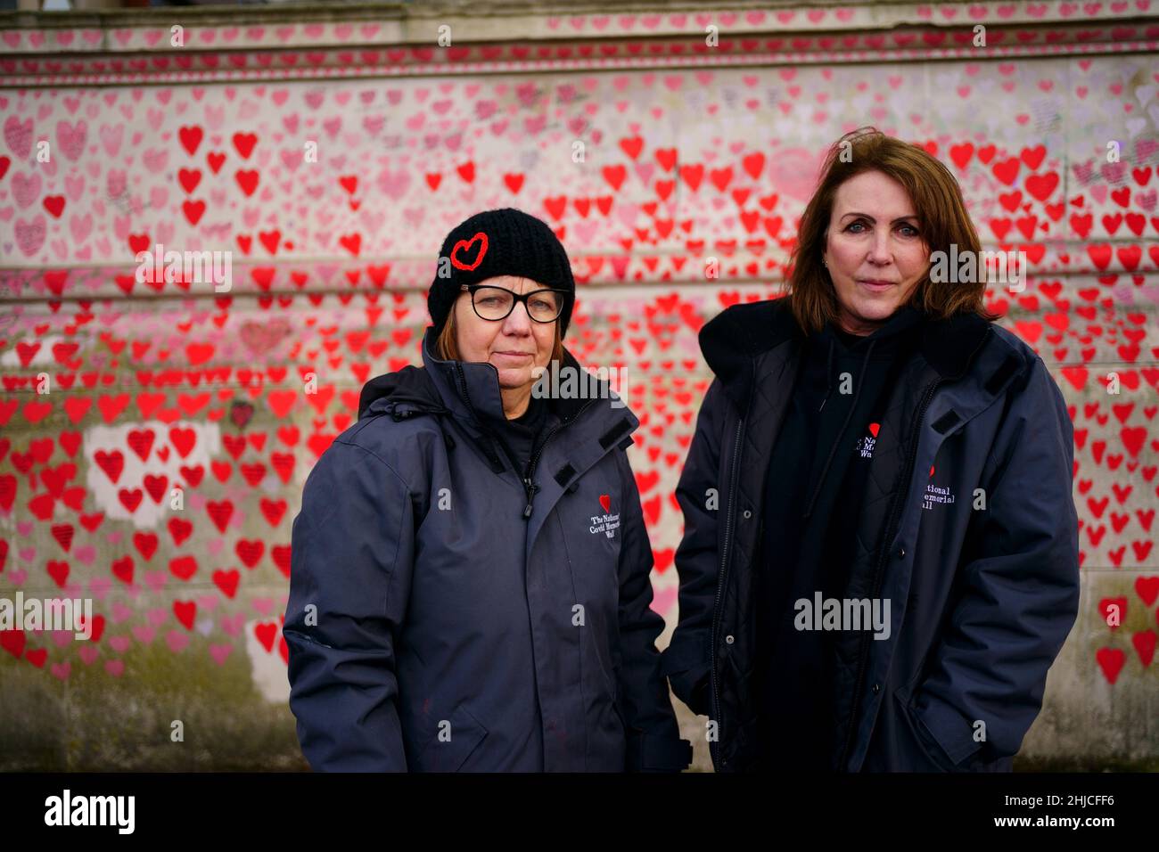 Lynn Jones (left) and Fran Hall from the Covid-19 Bereaved Families For Justice campaign group, standing by the National Covid Memorial Wall opposite the Palace of Westminster in central London. Picture date: Friday January 28, 2022. Stock Photo