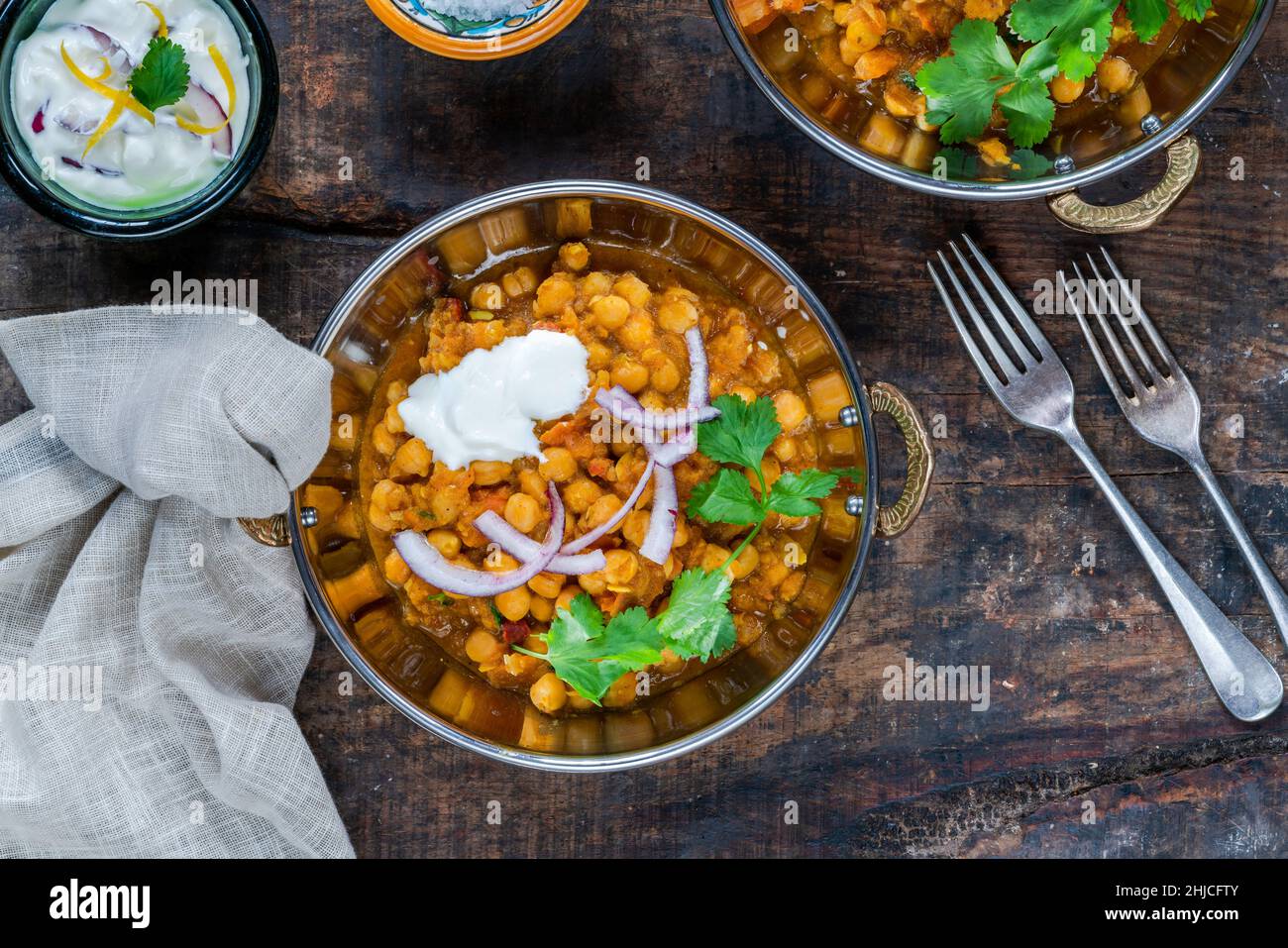Chickpea curry with red onion raita Stock Photo Alamy