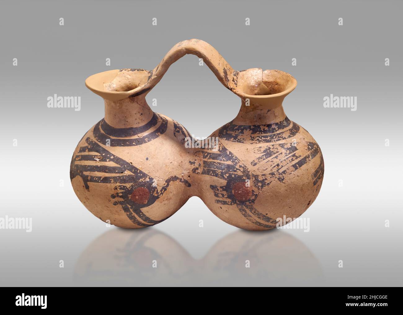 Mycenaean pottery . double jug with stylised bird design, Tumulus IQ, cist grave, Asine, 1700-1650 BC. Nafplion Archaeological Museum. Against grey ba Stock Photo