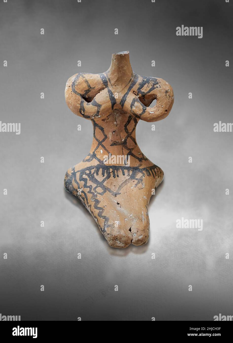 Neolithic Greek pottery female sitting figurine, Franchthi cave, 5300-4500 BC . Nafplio Archaeological Museum. Grey art background. Photographer Paul Stock Photo