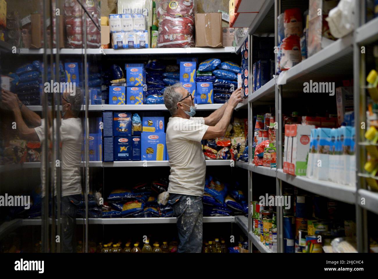 Valletta, Malta. 18th Jan, 2022. A staff member arranges foodstuff on a