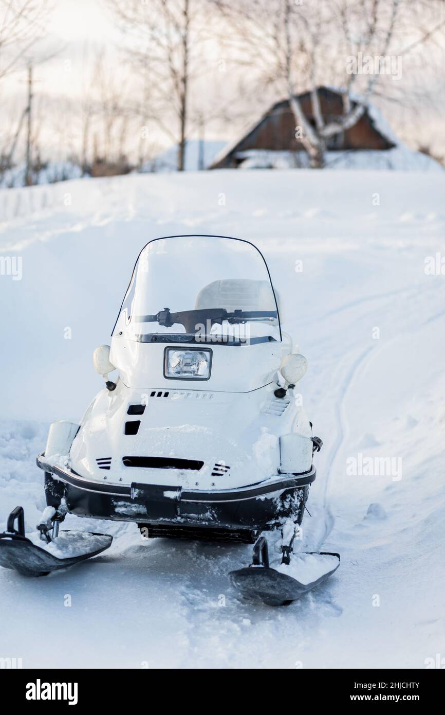 Snowmobile in winter conditions. Snowmobiling in winter in the north. Extreme kind of winter outdoor sport. Stock Photo