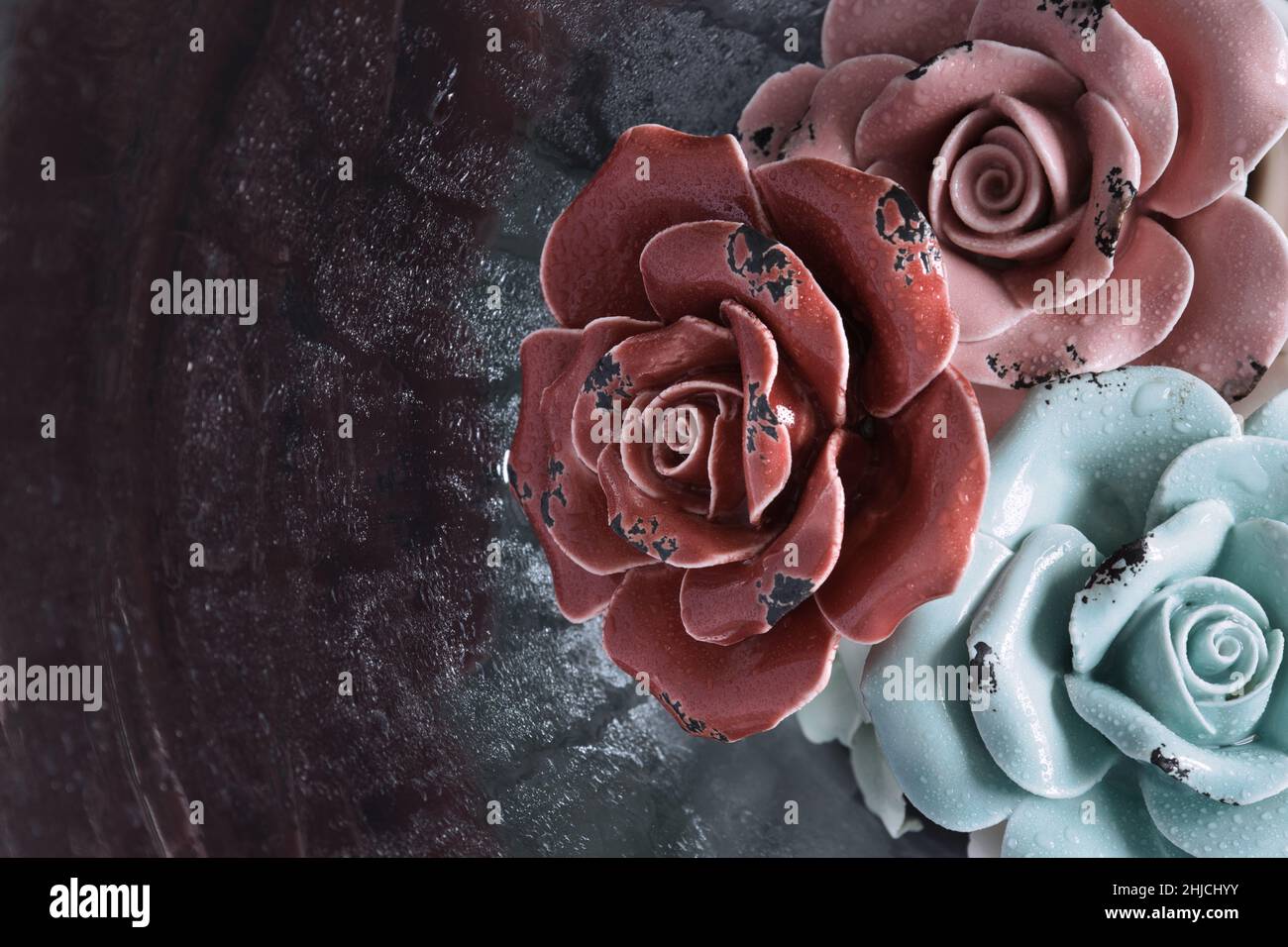 Ceramic Roses in Glass Vase with Waterdrops Stock Photo