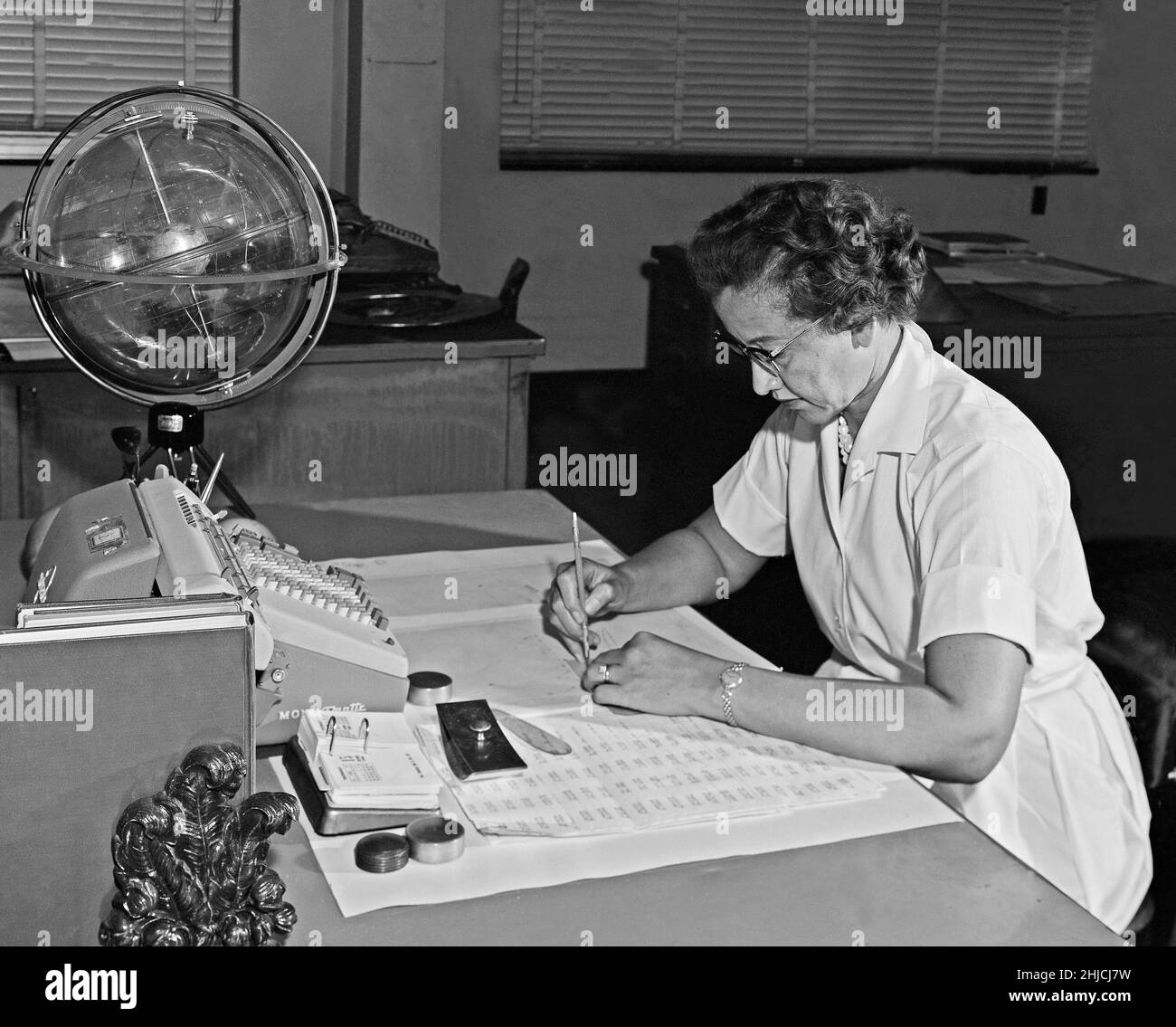 Katherine Johnson working at Langley Research Center, Virginia, in 1962. Johnson (1918-2020) was a US physicist and mathematician, one of a number of African-American women hired to work as 'computers' at NACA (the predecessor to NASA). She worked at Langley from 1953 until her retirement in 1986. Over the course of her career, she calculated the trajectory of the 1961 flight of Alan Shepard, the first American in space, as well as working on the Apollo mission and the Space Shuttle Program. Stock Photo