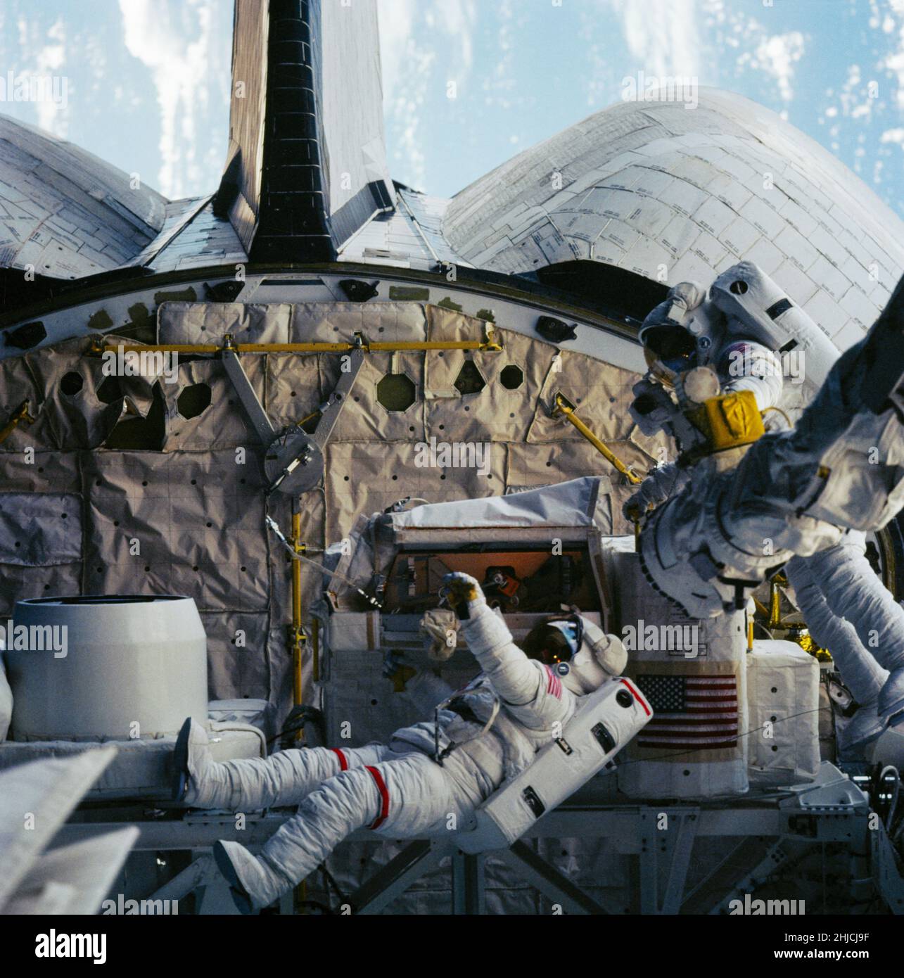 Photographed on October 11, 1984 through aft flight deck windows of the Space Shuttle Challenger, this 70mm frame shows Astronauts David C. Leestma, left, and Kathryn D. Sullivan at the orbital refueling system (ORS) in the aft cargo bay. Dr. Sullivan's part of the extravehicular activity (EVA) represented the first such feat for an American woman. Stock Photo