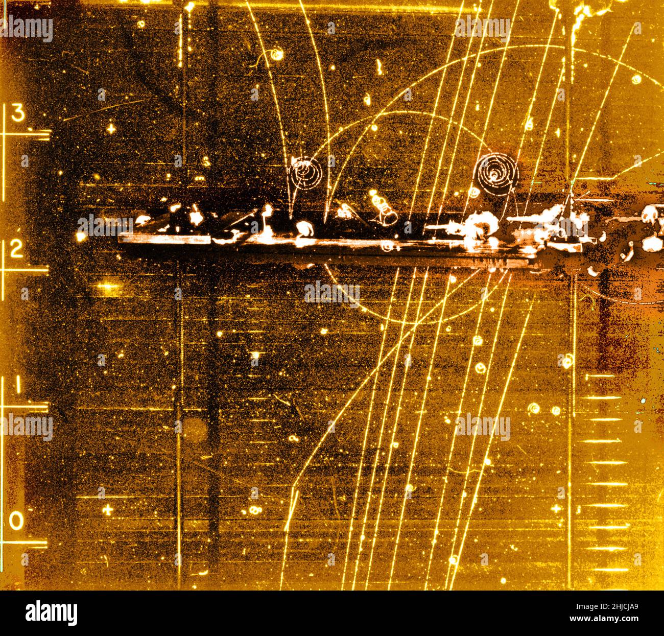 Bubble chamber event: Particles passing through lead shielding. November 17, 1964. Bubble Chamber-1408. Lead shielding refers to the use of lead as a form of radiation protection to shield people or objects from radiation so as to reduce the effective dose. Lead can effectively attenuate certain kinds of radiation because of its high density and high atomic number; principally, it is effective at stopping gamma rays, and x-rays. A bubble chamber is a vessel filled with a superheated transparent liquid (most often liquid hydrogen) used to detect electrically charged particles moving through it. Stock Photo