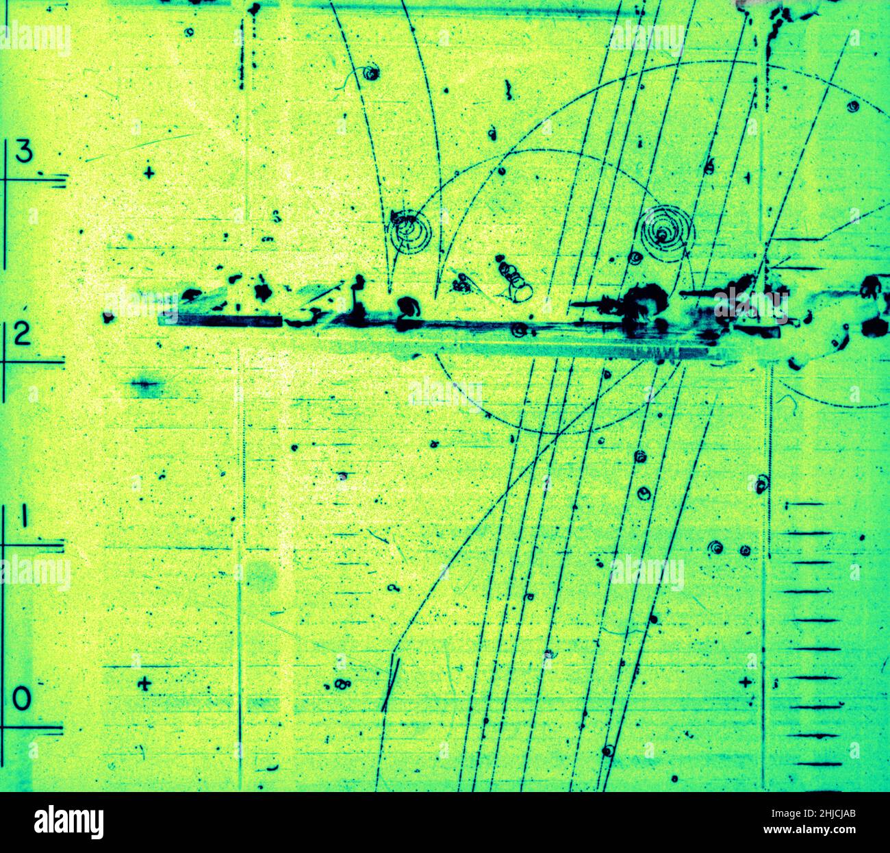 Bubble chamber event: Particles passing through lead shielding. November 17, 1964. Bubble Chamber-1408. Lead shielding refers to the use of lead as a form of radiation protection to shield people or objects from radiation so as to reduce the effective dose. Lead can effectively attenuate certain kinds of radiation because of its high density and high atomic number; principally, it is effective at stopping gamma rays, and x-rays. A bubble chamber is a vessel filled with a superheated transparent liquid (most often liquid hydrogen) used to detect electrically charged particles moving through it. Stock Photo