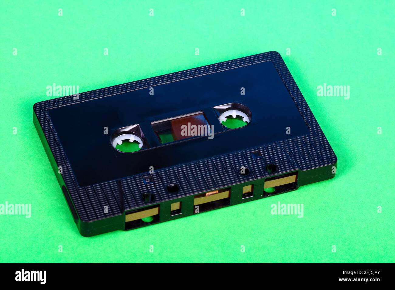 Vintage retro audio cassette tape isolated on a green background Stock Photo