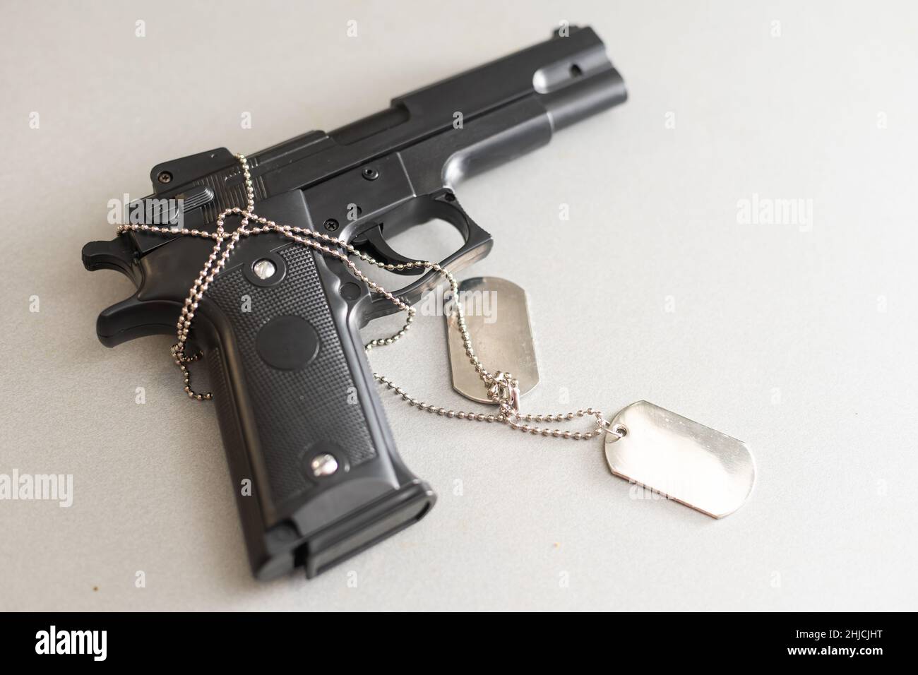 gun with dogtags. Concept of duty and service in US army forces. Veteran concept Stock Photo