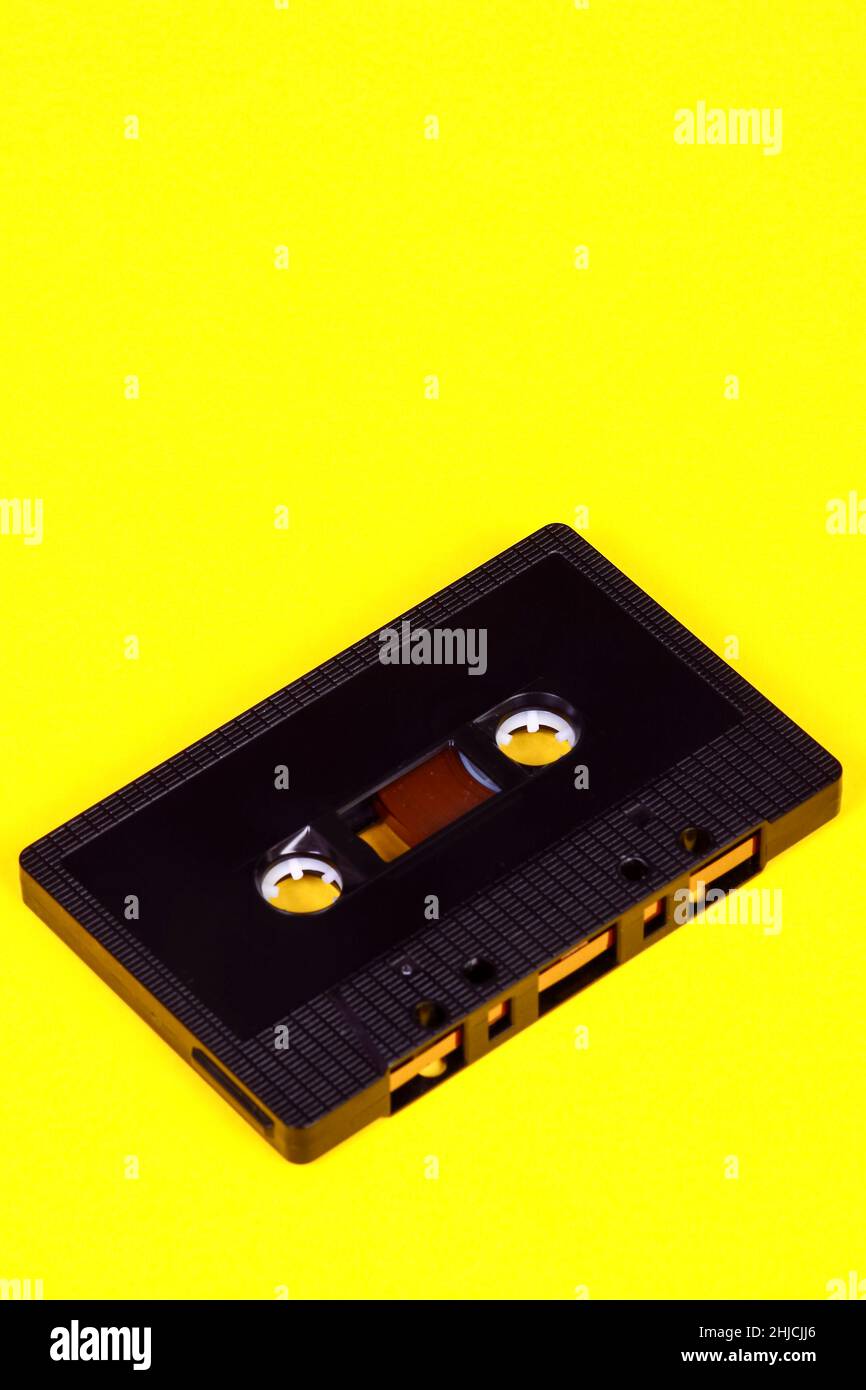 Vintage retro audio cassette tape isolated on a yellow background with