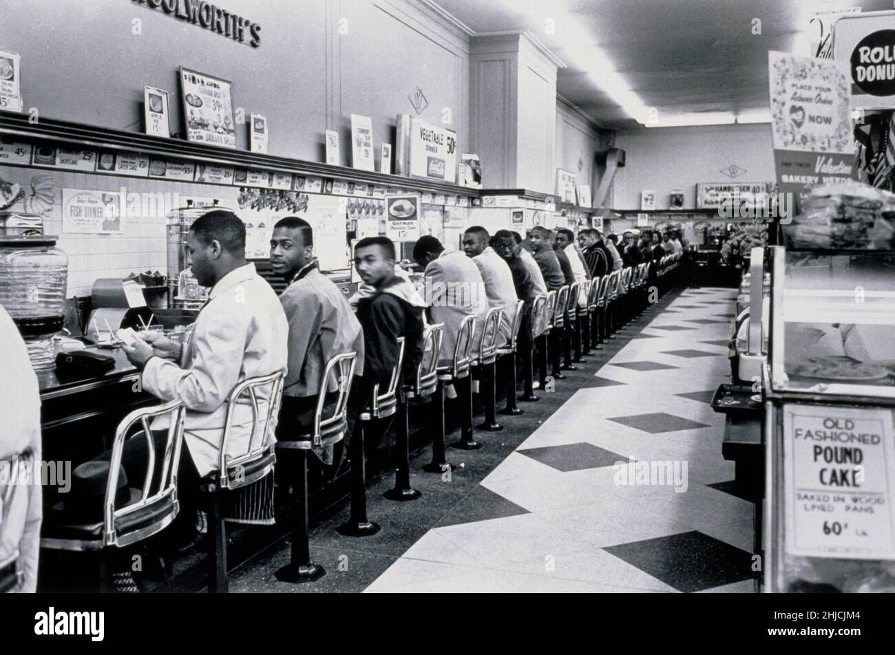 February 9, 1960, Charlotte, NC. The students had told the chief of police what they were going to do in advance. The chief of police had promised to make no arrests if they did it in an orderly way and he kept his word; no police ever appeared at the Charlotte sit-ins and there were no arrests. After a few hours, the students left and the stores put up signs saying their lunch counters were temporarily closed. On July 3rd, the counters at Woolworth's were reopened to everyone. Stock Photo