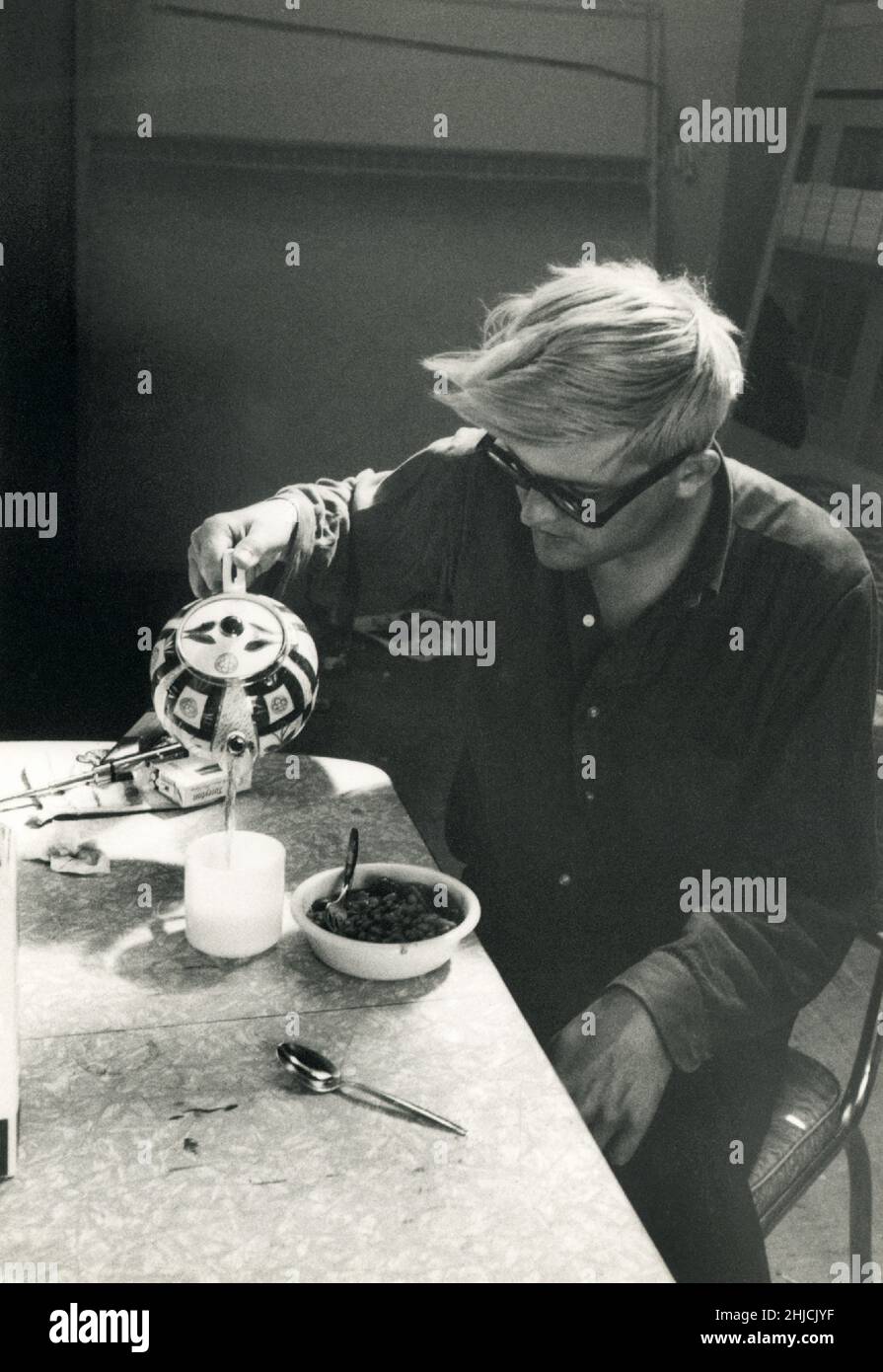 Painter David Hockney makes tea at his home studio in Los Angeles, 1966. Hockney was a major contributor to the British Pop art movement of the 1960's, and lives today in Los Angeles, California. Stock Photo