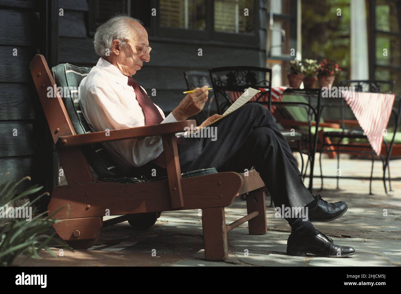 Aaron Copland (1900-1990), American composer, pianist, and conductor, at home working on music. Stock Photo
