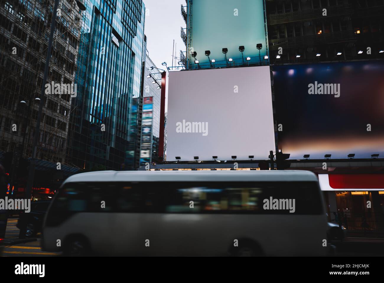 Modern bus driving along city Stock Photo - Alamy