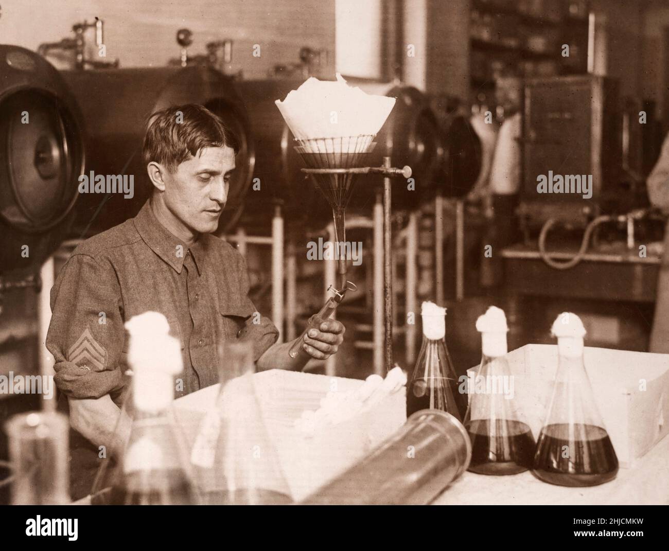 Making typhoid vaccine, 1917.  Filling tubes with broth to be inoculated. U.S. Army Medical School. Stock Photo