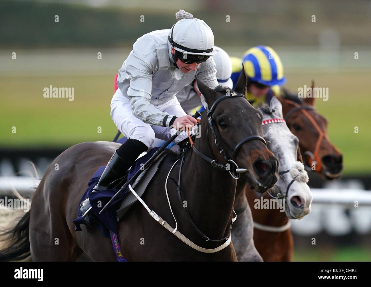 Andrew Breslin riding Enfranchise (left) on their way to winning the Play 4 To Win At Betway Handicap at Lingfield Park Racecourse, Surrey. Picture date: Friday January 28, 2022. Stock Photo