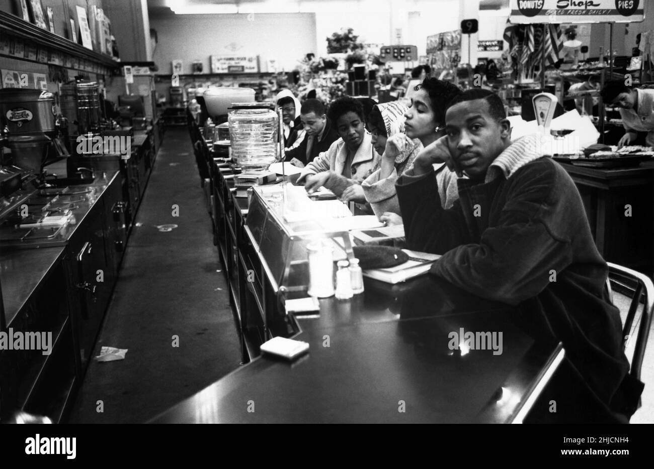 February 9, 1960, Charlotte, NC. The very first sit-in took place a week earlier in Greensboro, NC. The Charlotte sit-in was not well covered at the time, but it marked the fact that what had happened in Greensboro was spreading to other Southern cities. It was the college students from Johnson C. Smith University who took park in the sit-ins. These students also started picketing a downtown theatre to allow blacks to sit downstairs in the theater. The sit-ins had taken store management by surprise; Stock Photo