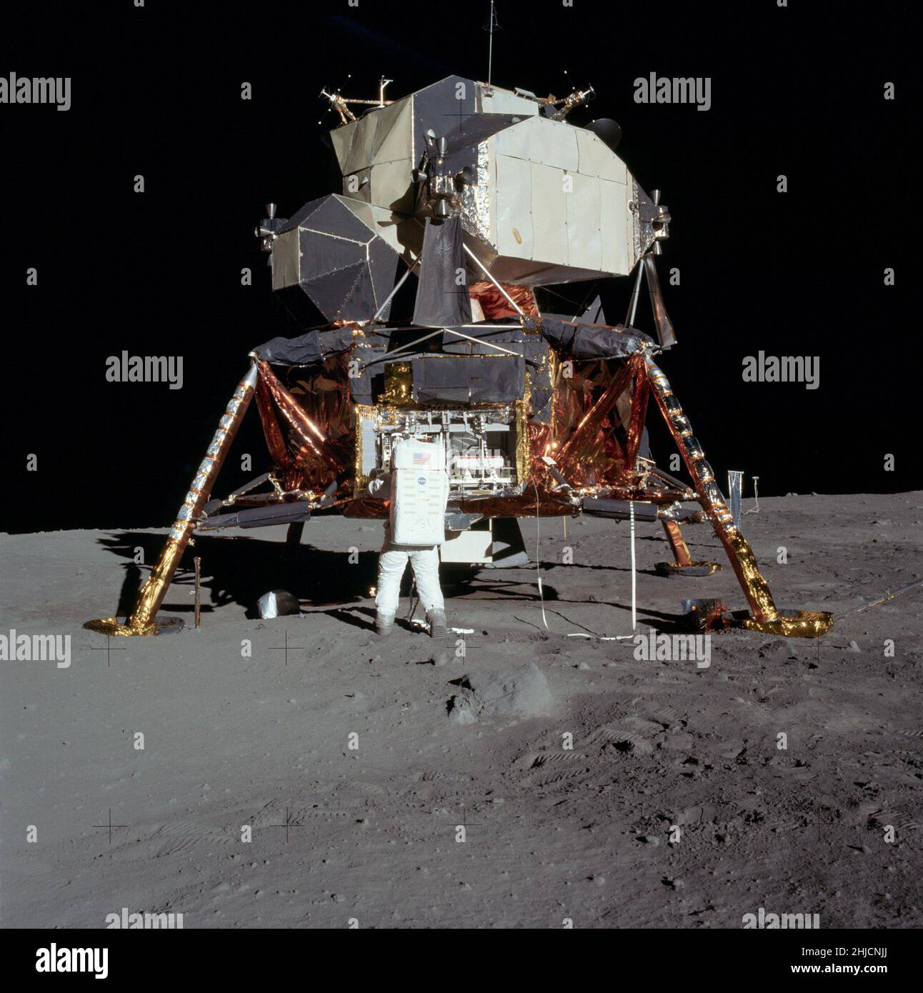 Buzz is preparing to remove the passive seismometer from the a compartment of the lunar module. First manned mission to moon. Stock Photo