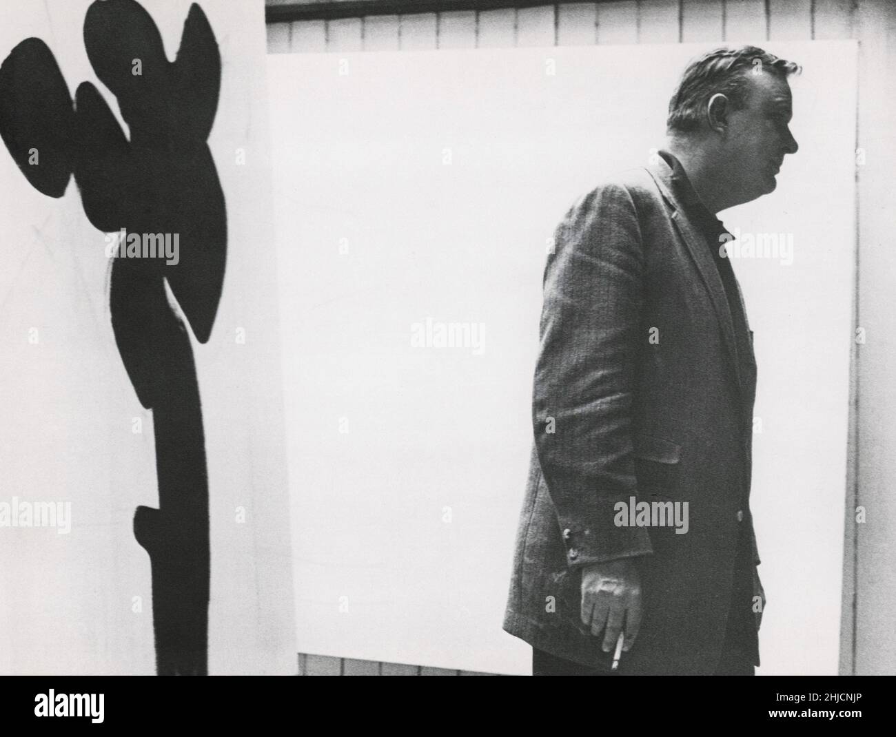 American abstract expressionist painter Robert Motherwell (1915-1991) with one of his paintings in New York City, 1958. Stock Photo