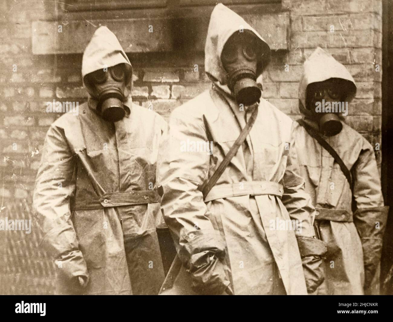 Three French army surgeons wearing gas masks in the course of their medical duties, WWI.  Circa 1917-18. Stock Photo