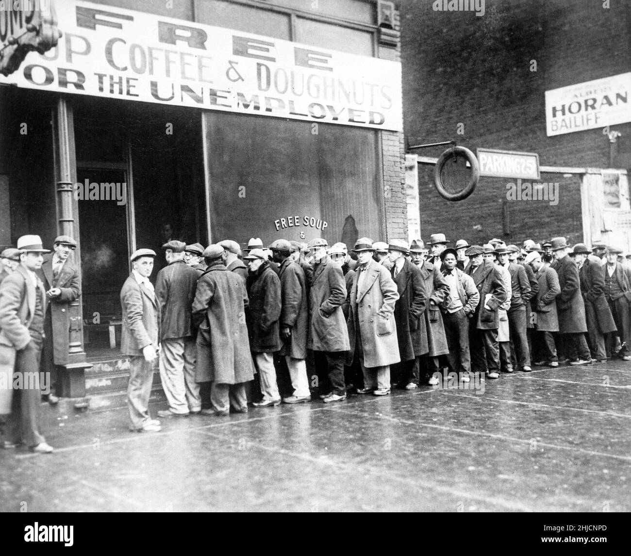Unemployed men queued outside a Depression Era soup kitchen opened by Al Capone in Chicago, February, 1931. Stock Photo