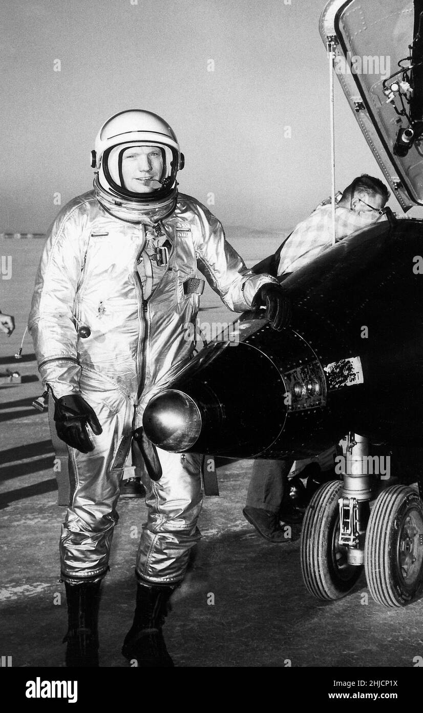 NASA test pilot Neil Armstrong is seen here next to the X-15 ship #1 (56-6670) after a research flight. The X-15 was a rocket-powered aircraft 50 feet long with a wingspan of 22 feet. It was a missile-shaped vehicle with an unusual wedge-shaped vertical tail, thin stubby wings, and unique side fairings that extended along the side of the fuselage. Armstrong later commanded the Apollo 11 mission, and was the first person to step foot on the moon. Stock Photo